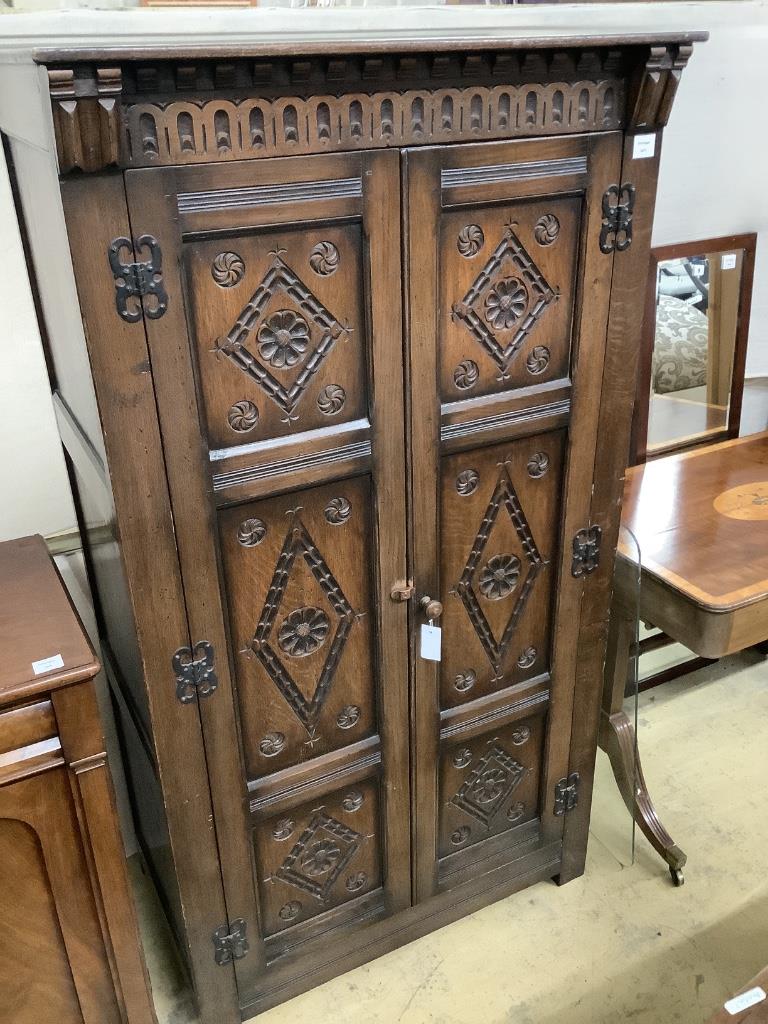 An 18th century style carved panelled oak wardrobe, width 95cm depth 58cm height 174cm